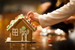 A child building a gingerbread house.