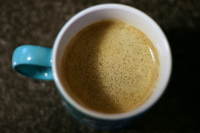 Looking into a cup of coffee with milk.