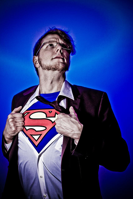Man wearing a Superman costume under his dress clothes.