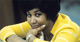 Image of Aretha Franklin in a yellow shirt.
