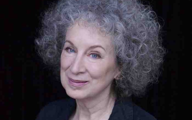 Headshot of a woman with curly gray hair.