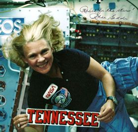Autographed photo from Margaret Rhea Seddon showing her floating in the space shuttle.