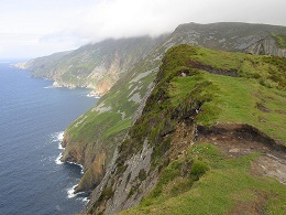 A landscape photo showing craggy hills by the sea.