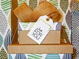 Stack of birthday presents with a tag that reads Just For you.