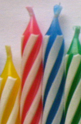 Yellow, red, blue, and green birthday candles.