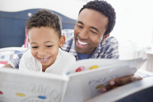 parent and child reading and laughing together