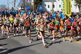 A large group of people running the Boston Marathon.