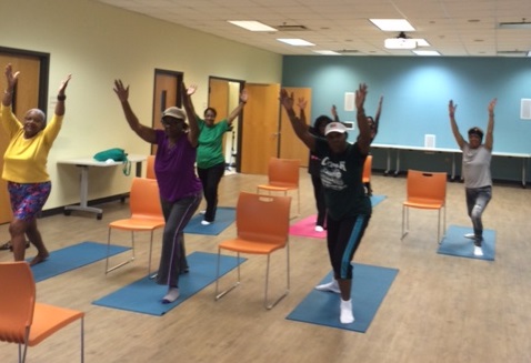 Group of women doing yoga at a library.