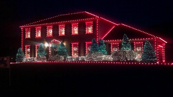 House at night trimmed in red lights.