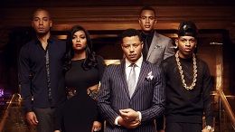 Still from the show Empire showing 5 people dressed up in a wood paneled room.