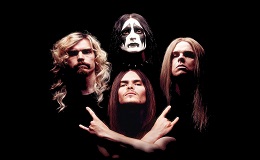 Four men, one of them in KISS band makeup.