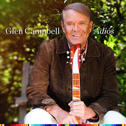 Glen Campbell's "Adiós" album cover, showing him outdoors holding a guitar neck against a sunlit greenery background.