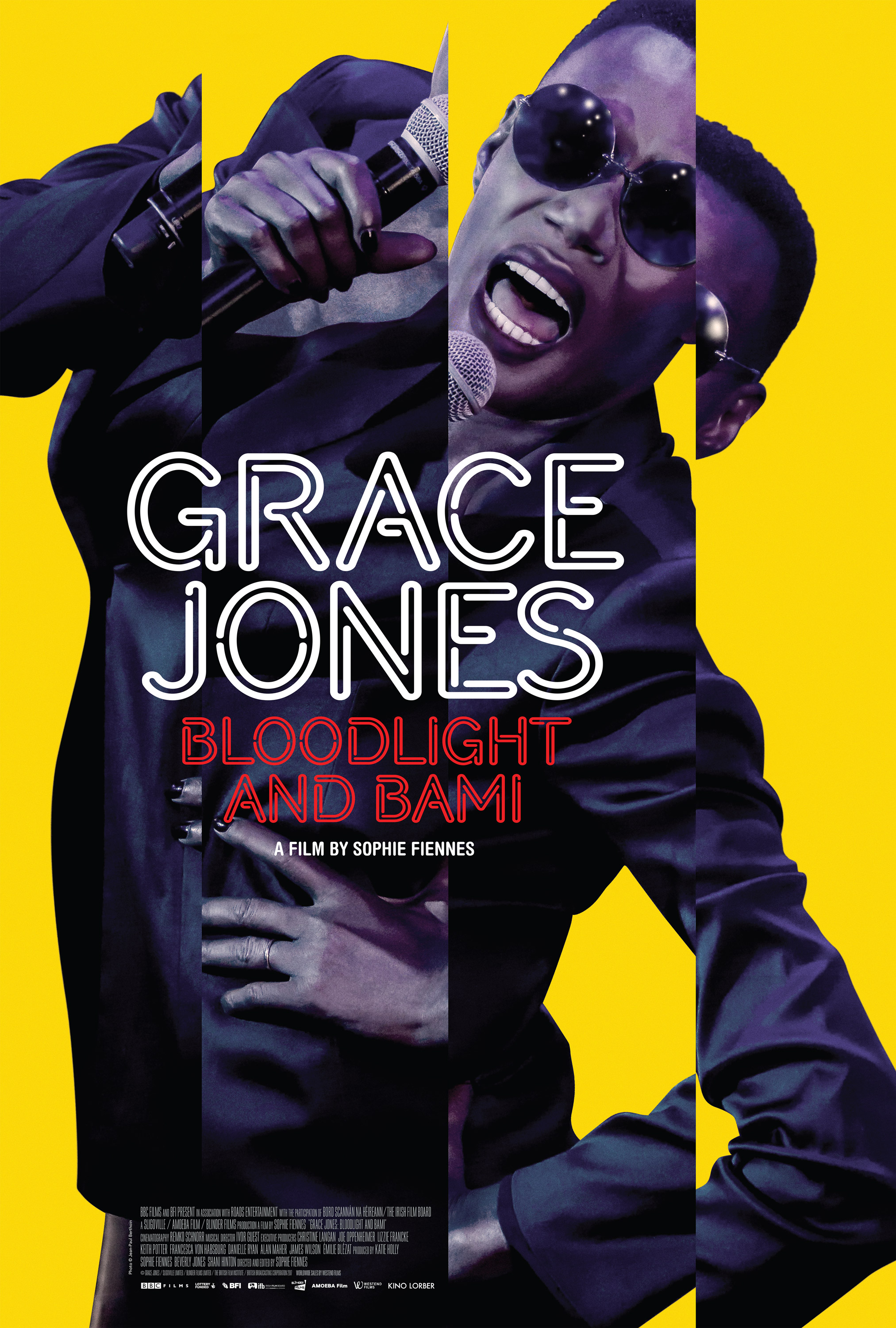 Movie poster for Grace Jones: Bloodlight and Bami showing a woman wearing black on a bright yellow background.