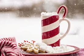 Red and white stripe mug on a table in the snow.