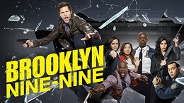 Promotional image for Brooklyn Nine-Nine showing the cast in the background with one cast member jumping through a window.