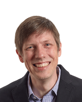 Headshot of Jeff Mack with short brown hair, a gray shirt, and a dark blazer.
