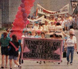 People march in parade. Carry banners.