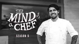 Man stands in front of window that reads the mind of a chef.
