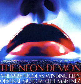 Movie poster for "The Neon Demon" featuring a close-up of glossy red lips against a blue-toned background.