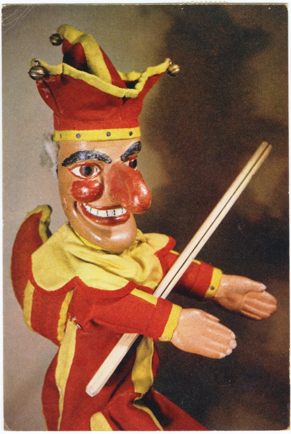 Punch puppet wearing a red and yellow suit.