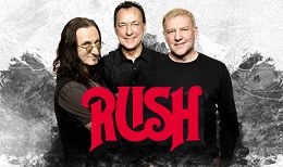The rock band Rush's three members smile together behind a bold red "RUSH" logo on a textured white background.