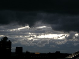 Stormy, dark weather over a cityscape.