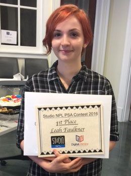 Woman holding a certificate for winning a PSA contest.
