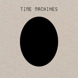 The words "time machines" with a black egg shape below