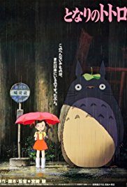 Japanese poster for My Neighbor Totoro, showing Satsuki with a red umbrella standing next to Totoro at a rainy bus stop.