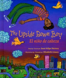 Colorful cartoon book cover of The Upside Down Boy, with boy in green pants floating upside down over a town.