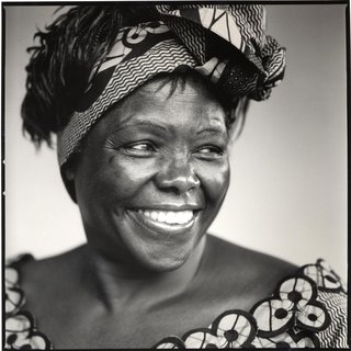 Black and white photo of smiling Black woman wearing hair band and looking to the side.