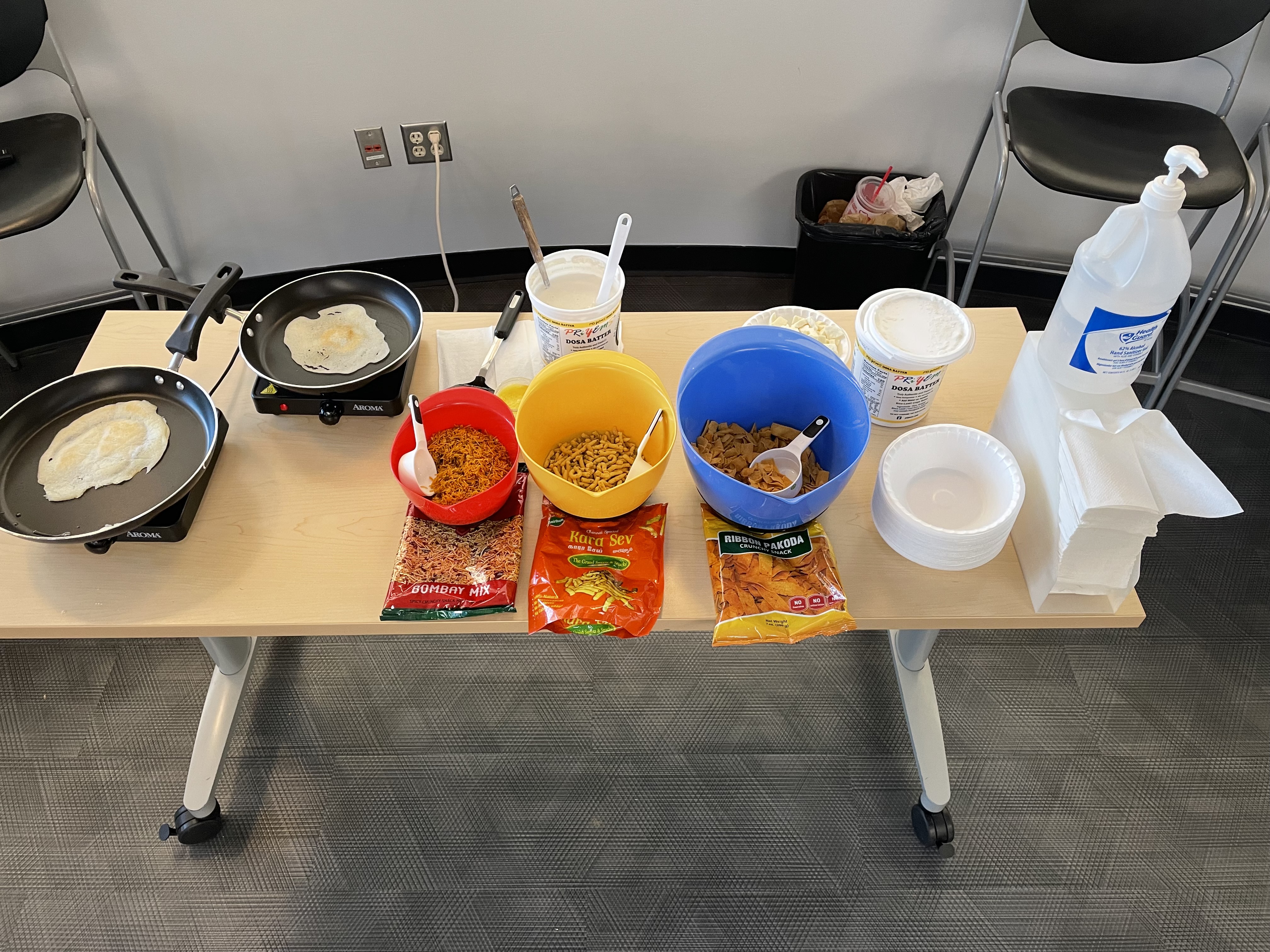 Cooking class supplies including ingredients and skillets sitting on a table.