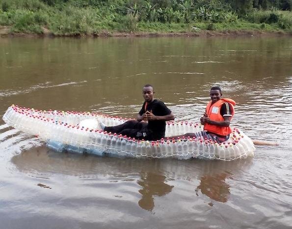 Two men in small boat made entirely of plastic bottles.