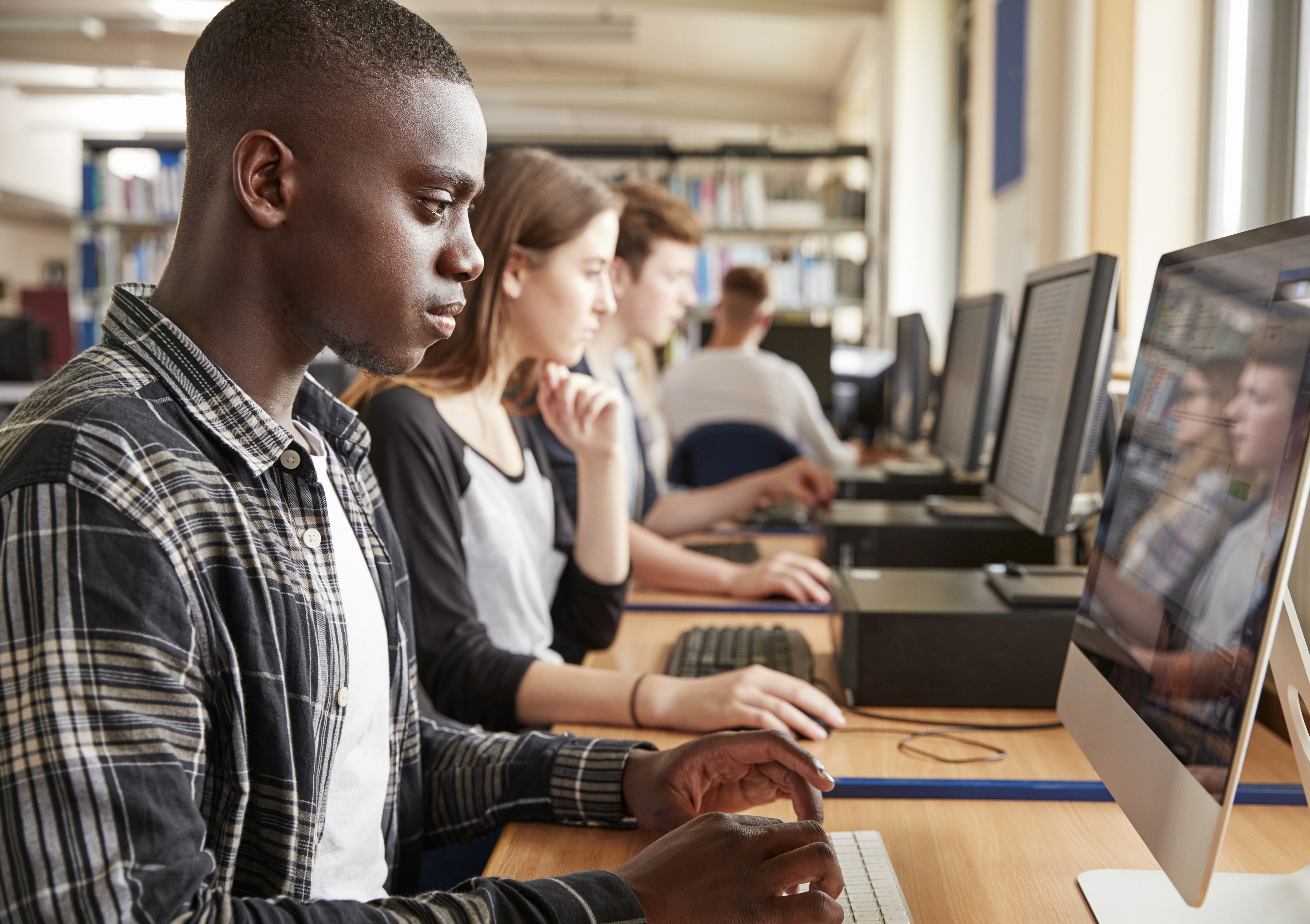 Young people using computers in a classroom or lab.