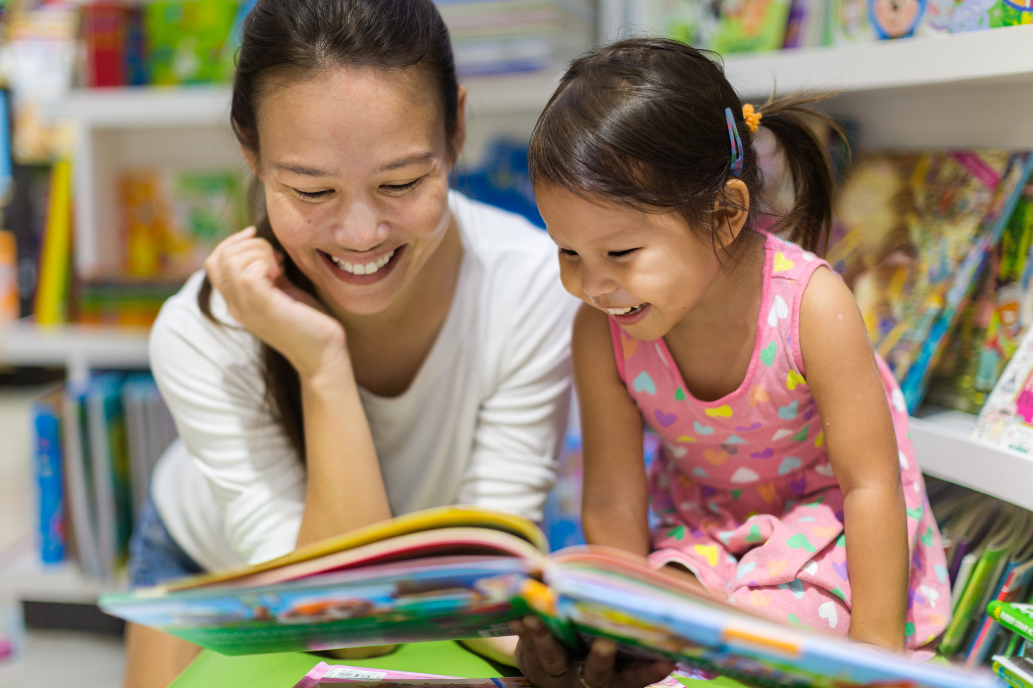 Mother and toddler reading a picture book.