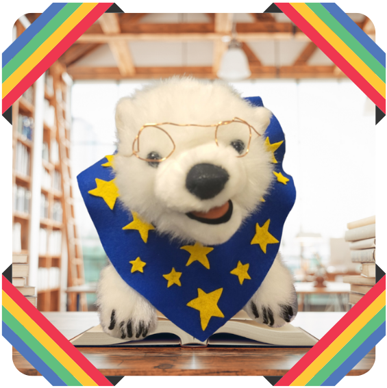 Vanilla, a polar bear, sitting on a book