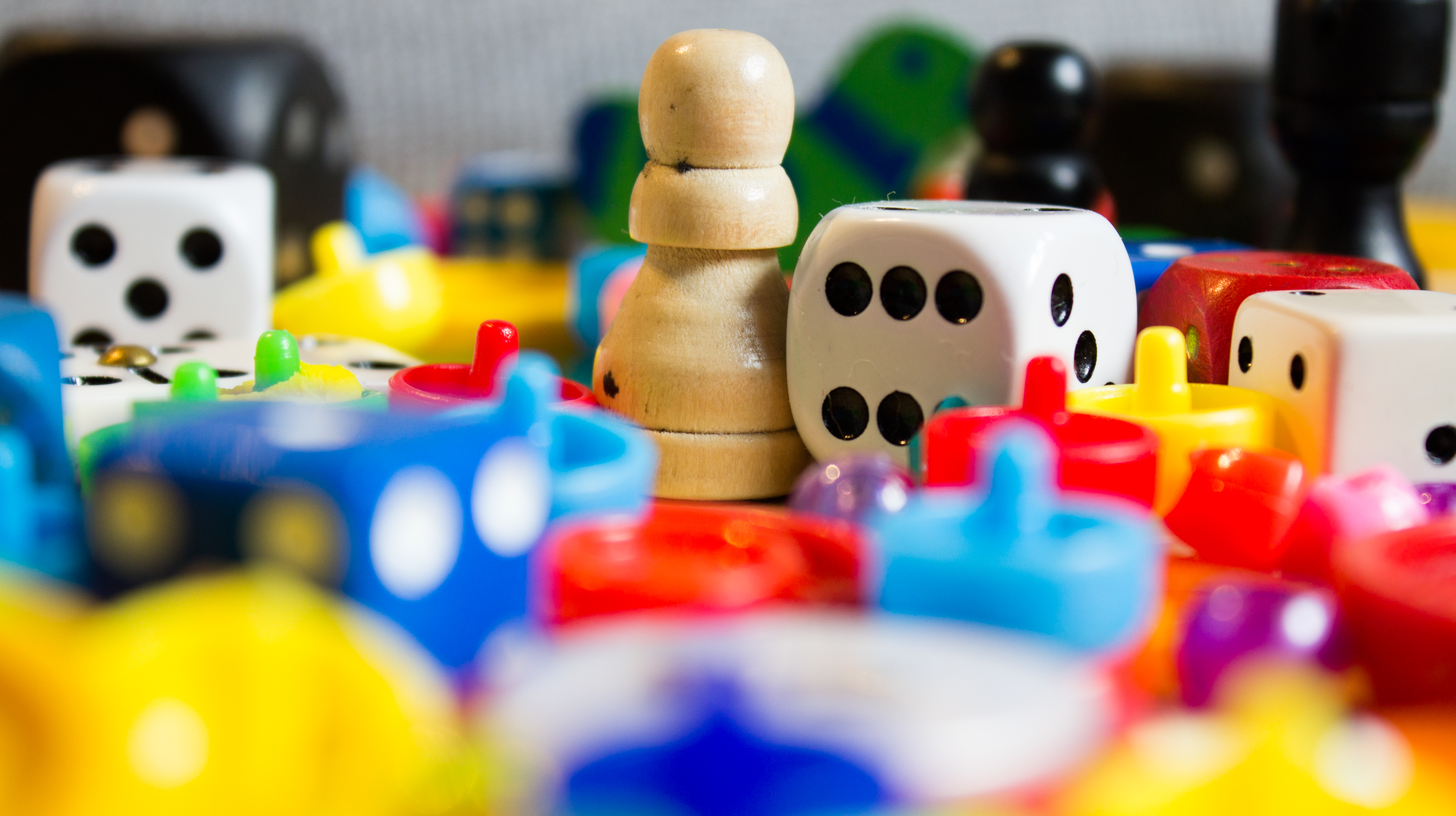 Assortment of colorful board game pieces and dice.