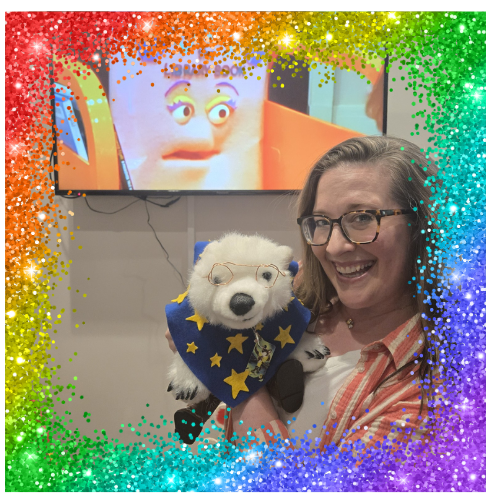 Evelyn holding Vanilla in front of a TV