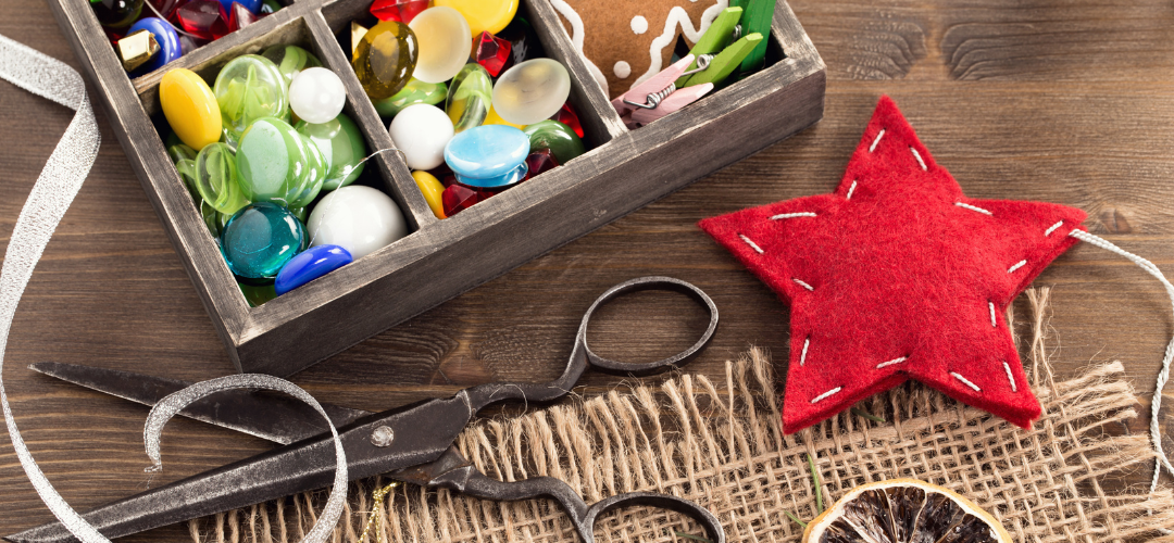 Scissors, crafting buttons, and sewn felt star. 