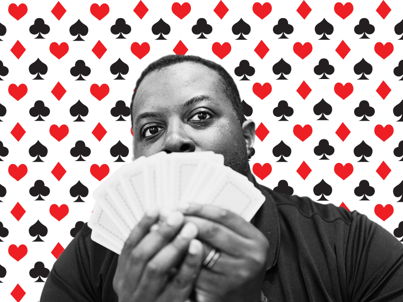 Photograph. Man holding hand of cards.