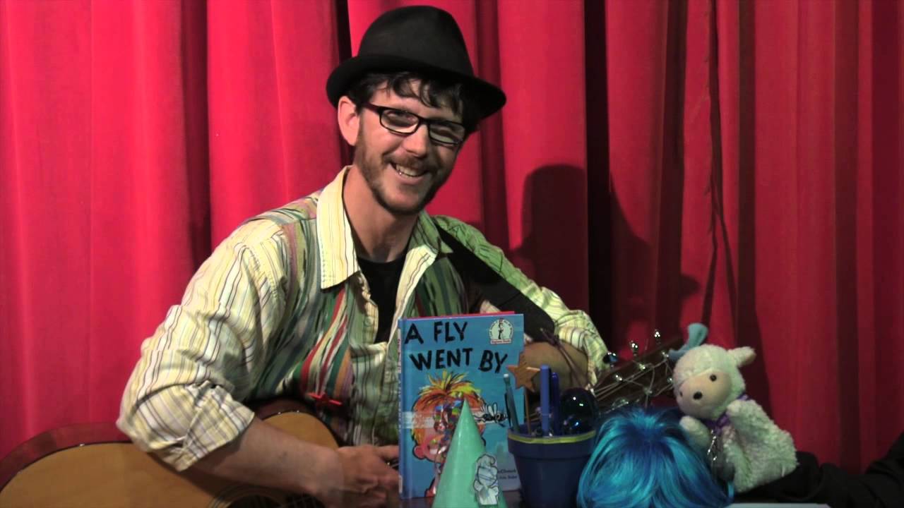 Man wearing fedora, playing accordian