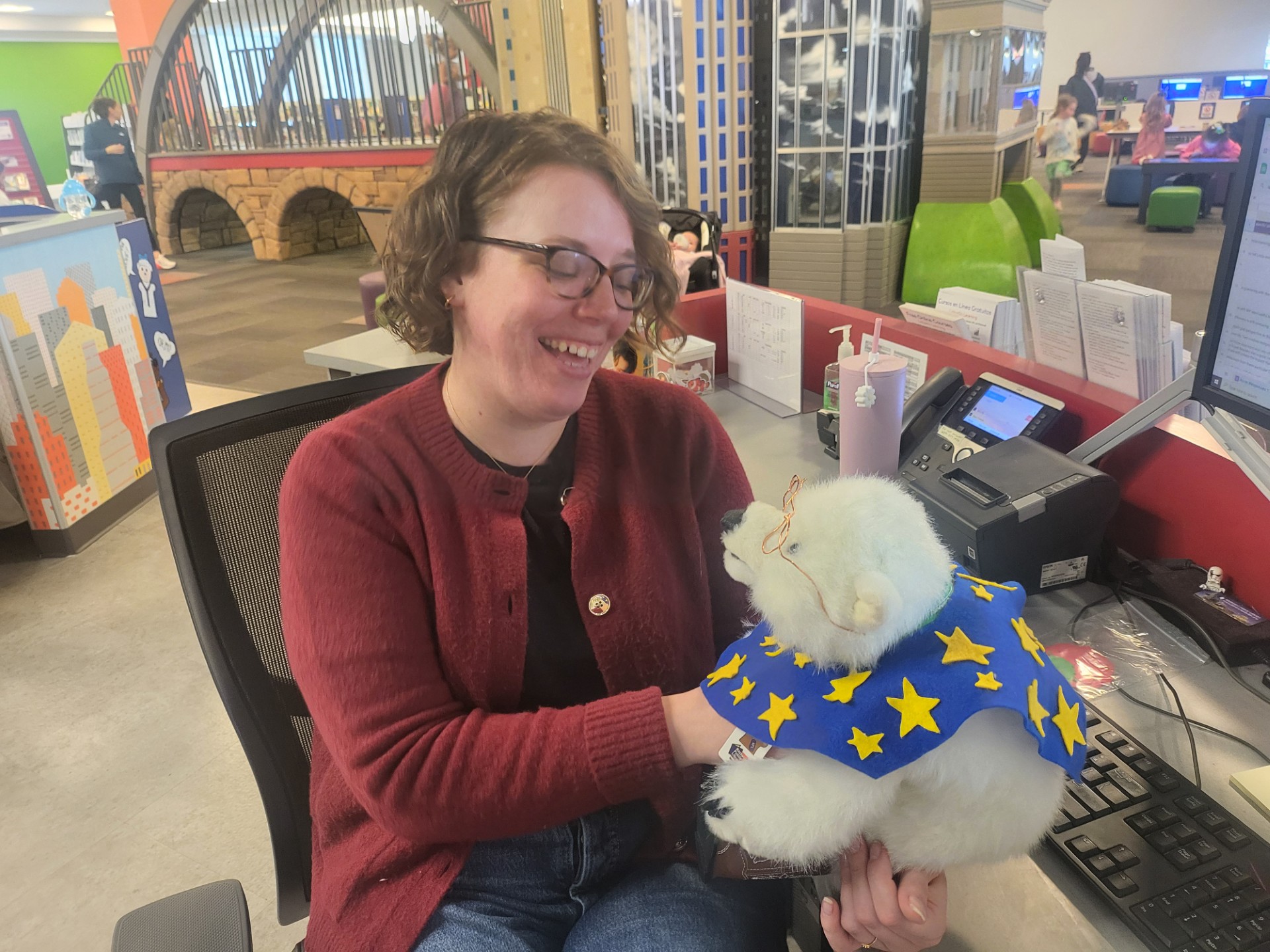 Librarian Nikki holding Vanilla and smiling.