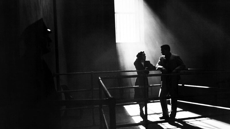 two people standing together in the darkness