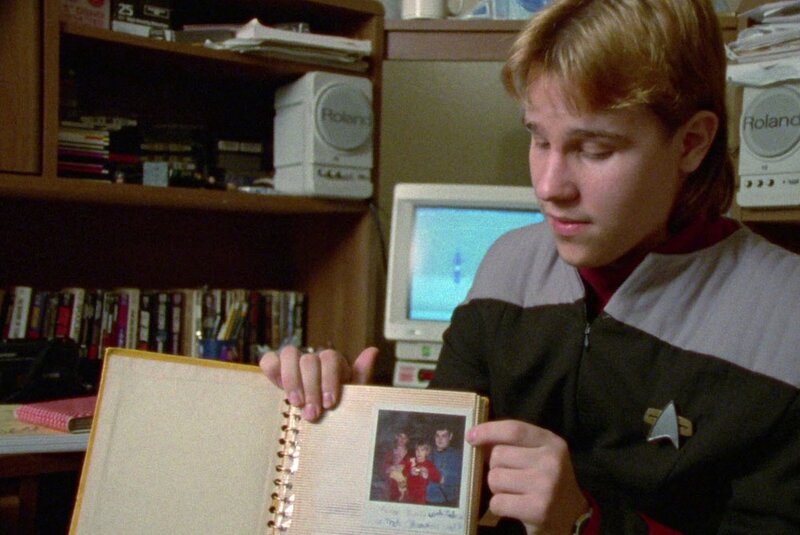 a fan shows off his scrapbook