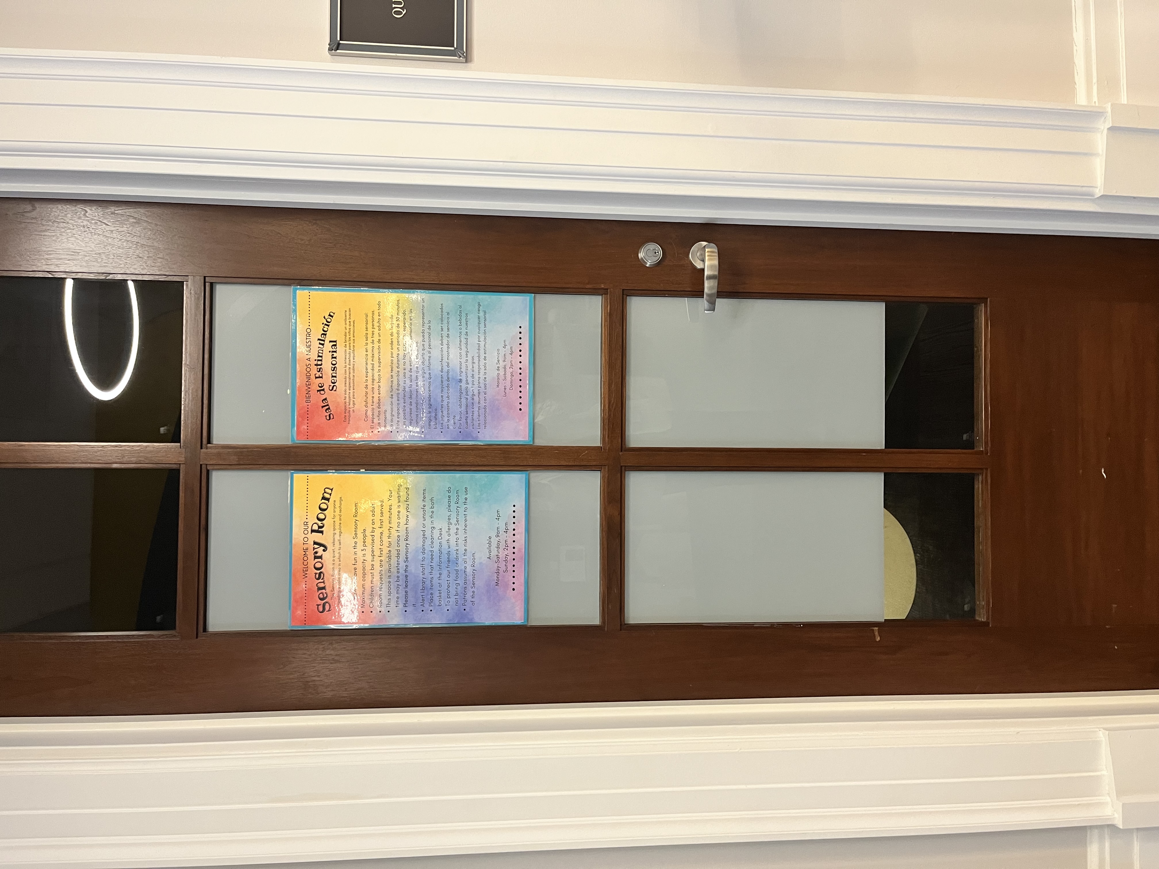 Door with a sign for "sensory room" taped to the glass