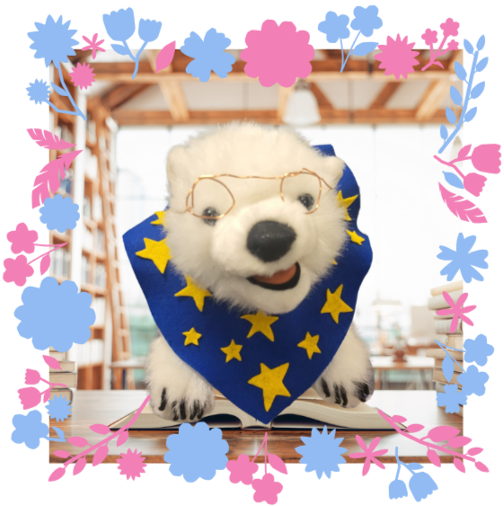 Vanilla, a polar bear, sitting on a book in a frame 