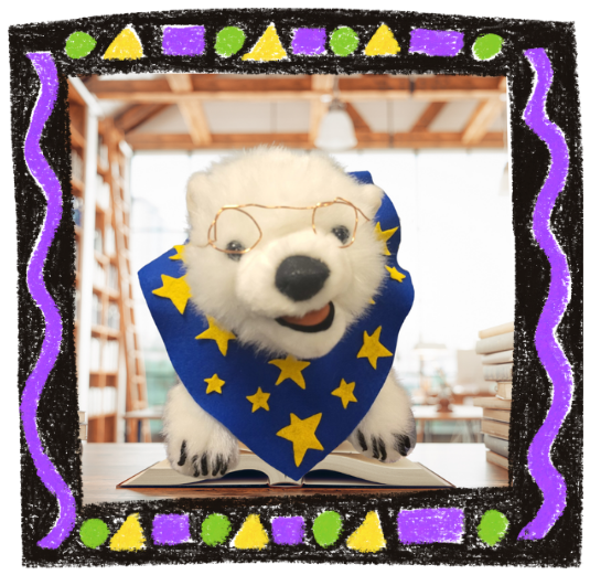 Vanilla, a polar bear, sitting on a book