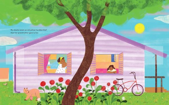 Pink house against a blue sky with a large green tree.