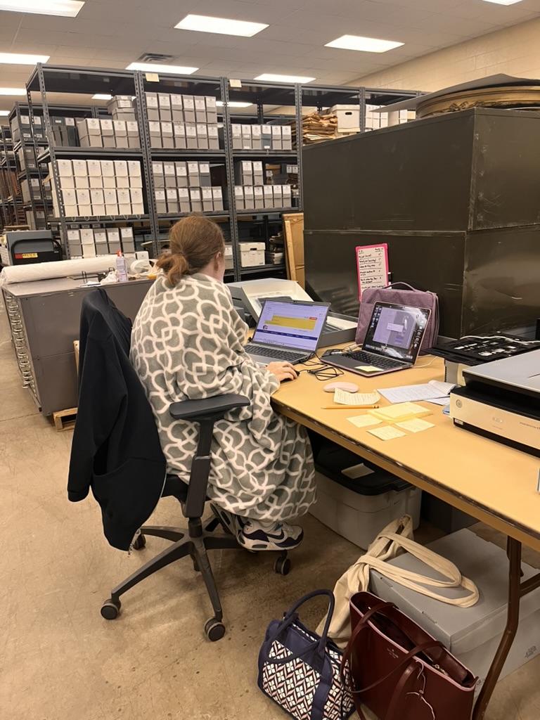 female library staffer working at a computer