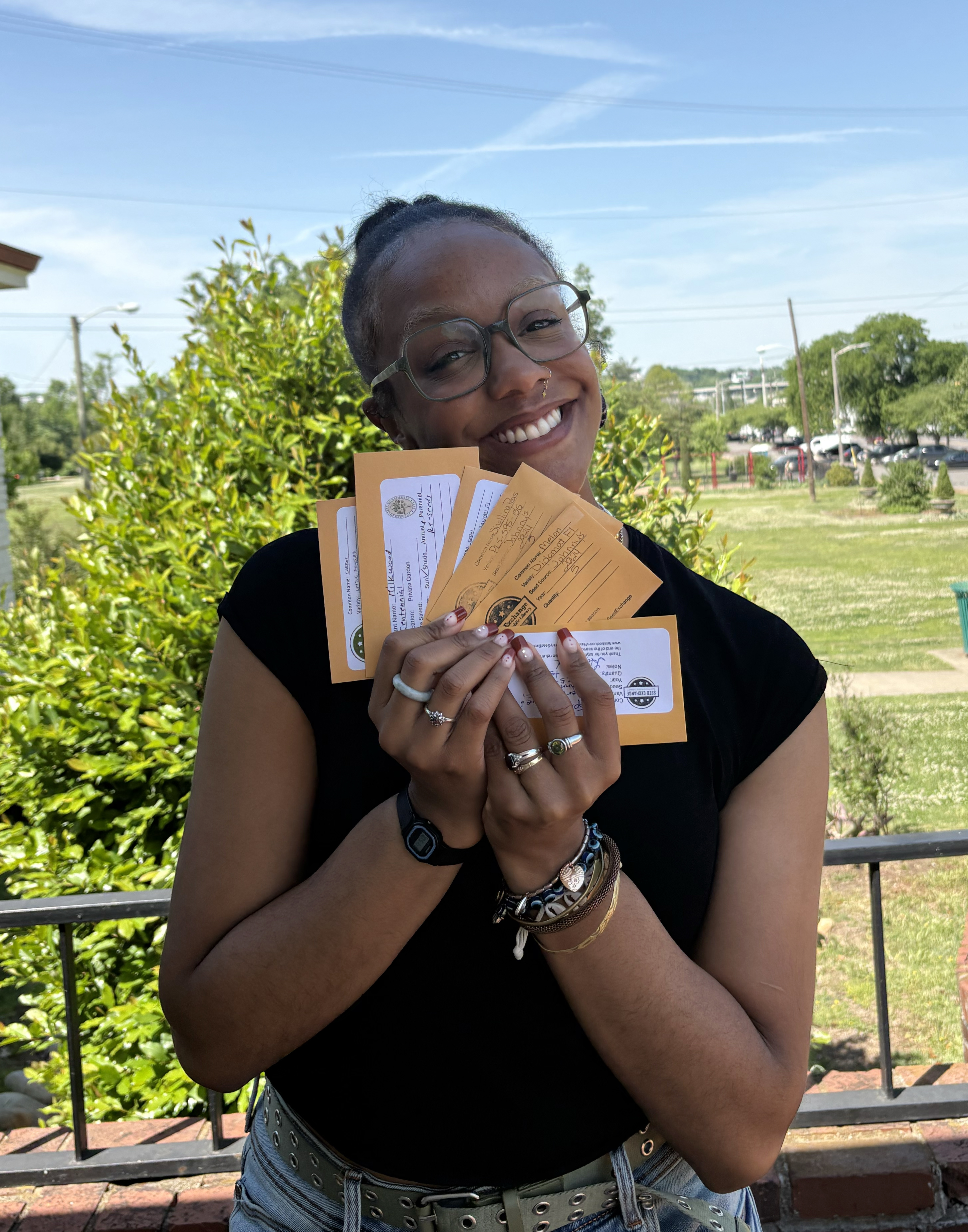 Library Associate Ember shows the wide variety of seeds available through the Seed Exchange at NPL.